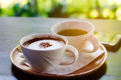 Close-up of cappuccino served on table