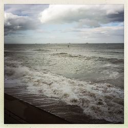 Scenic view of sea against cloudy sky