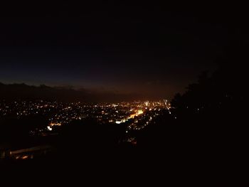 High angle view of illuminated buildings against sky at night