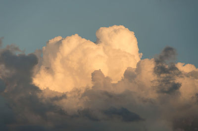 Low angle view of sunlight streaming through clouds