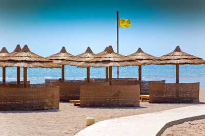 Built structure on beach against clear blue sky