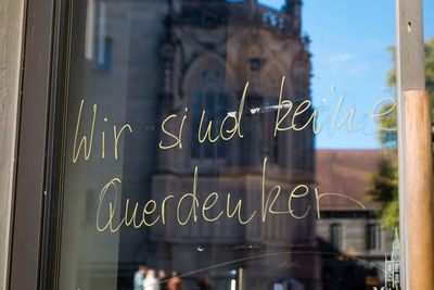 Close-up of text on glass window