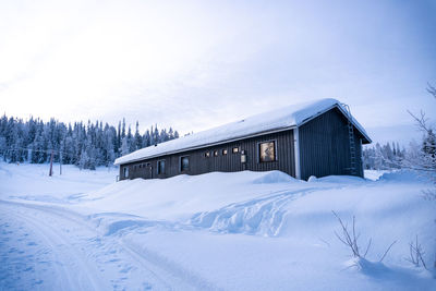 House on snow covered landscape