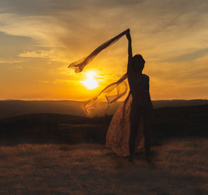 Silhouette of a woman at sunset