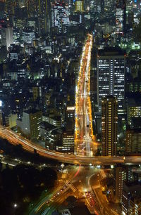 Aerial view of illuminated city street and buildings at night