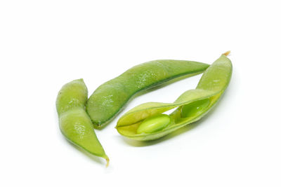 Close-up of green chili pepper against white background