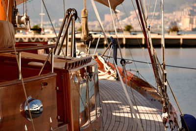 Sailboats moored at harbor