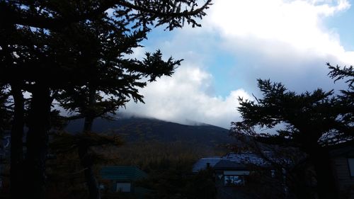 Scenic view of mountains against cloudy sky