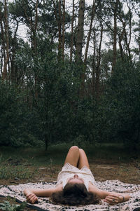 Low section of woman relaxing on land