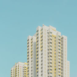 Low angle view of buildings against clear blue sky