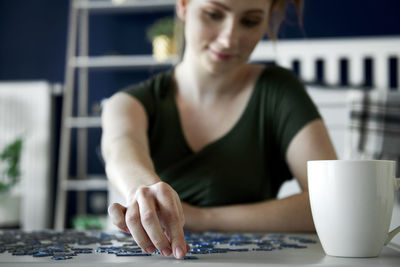 Midsection of woman sitting at table
