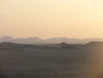 Scenic view of landscape against sky during sunset on deseet