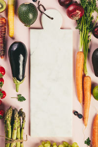 High angle view of vegetables and fruits with cutting board on table