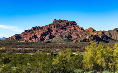 Scenic view of mountains against clear blue sky