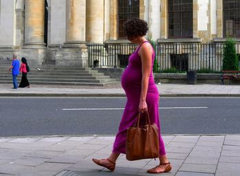 Rear view of man and woman walking outdoors