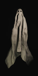 Low angle view of woman against black background