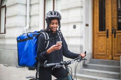 Young woman riding bicycle in city