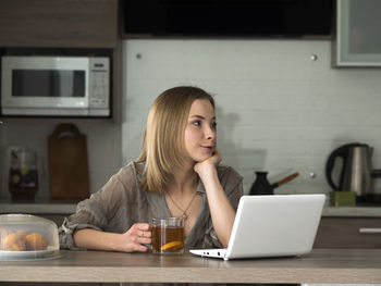 Woman using laptop on table