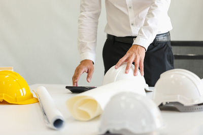 Midsection of man working at table