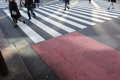 Low section of people walking on road