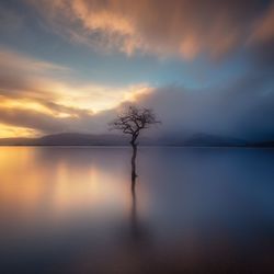 Scenic view of sea against sky at sunset