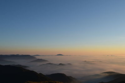 Scenic view of mountains against sky at sunset