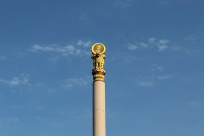 Low angle view of architectural column against blue sky