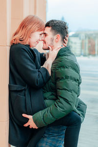 Side view of couple holding hands