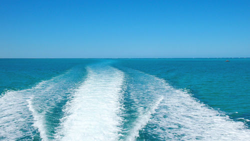 Scenic view of sea against clear blue sky