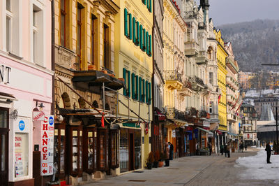 Footpath amidst buildings in city