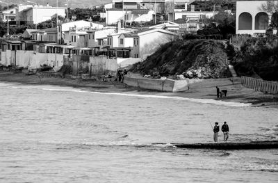 People fishing at coastline