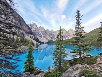Mountains reflecting in the water at moraine lake in banff national park