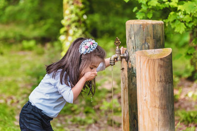 Girl drinking water at park