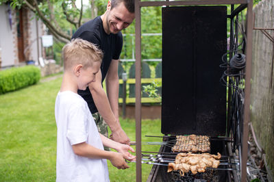 Side view of young man preparing food