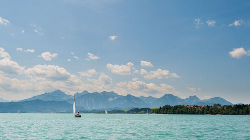 Sailboat in sea against sky