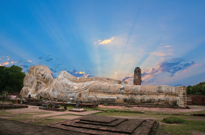 Statue of temple against cloudy sky