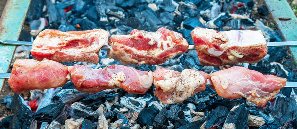 High angle view of meat on barbecue grill