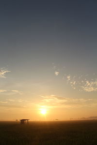 Scenic view of field against sky during sunset