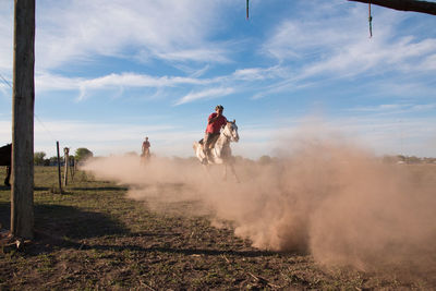 Men riding horse