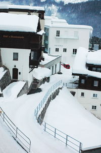 High angle view of snow covered houses in city