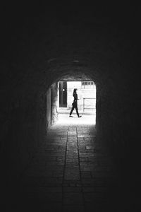 Woman walking in tunnel