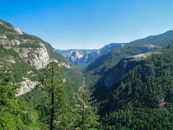 Scenic view of mountains against clear blue sky