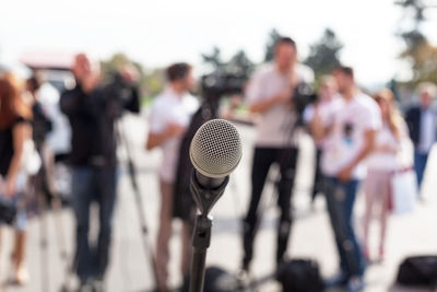 Close-up of microphone against crowd