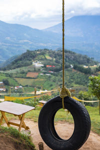Close-up of clothes hanging on field against mountains