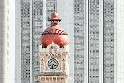 Clock tower against building in city