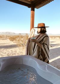 Rear view of man standing at beach