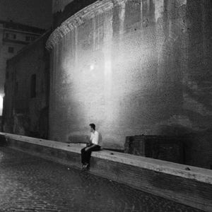 Full length of woman standing against wall