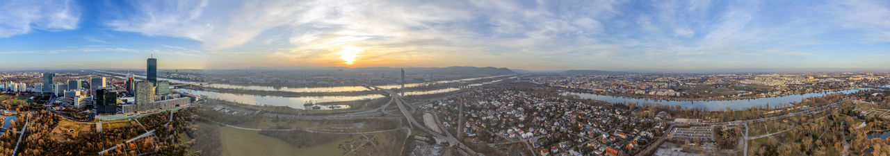 Aerial view of cityscape against sky during sunset