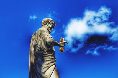 Low angle view of statue against blue sky