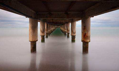 Reflection of pier on sea